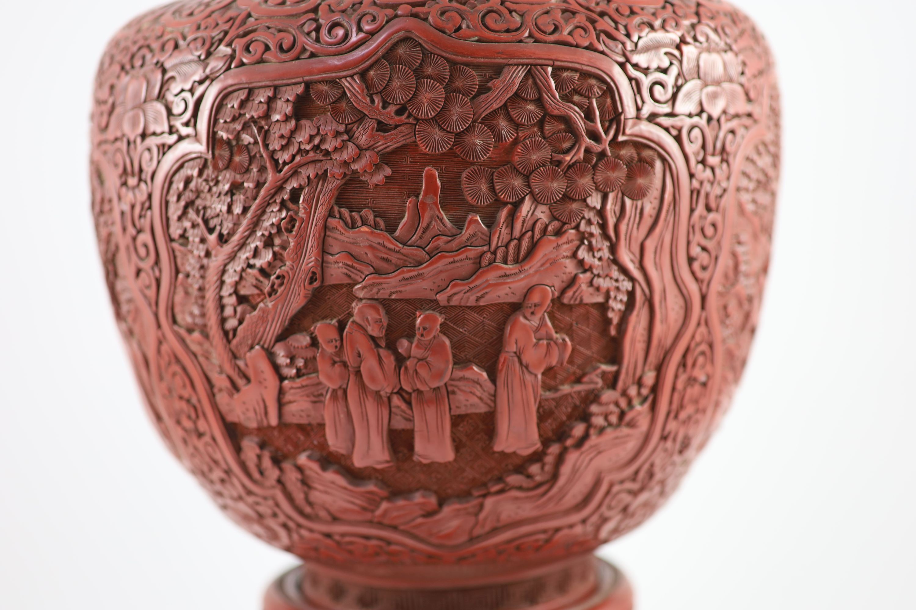 A large Chinese cinnabar lacquer garlic-neck vase and stand, c.1900, Total height 60.5 cm, base of vase drilled